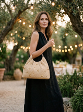 Load image into Gallery viewer, Artisanal Studded Handwoven Raffia Bag with Sculptural Gold Ring Handle