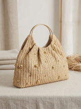 Load image into Gallery viewer, Artisanal Studded Handwoven Raffia Bag with Sculptural Gold Ring Handle