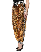 Load image into Gallery viewer, Dolce &amp; Gabbana Metallic Gold DG Logo Sequined Jogger Pants

