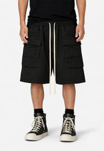 Load image into Gallery viewer, NOIR DROP-CROTCH CARGO SHORTS

