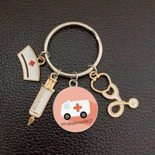 Load image into Gallery viewer, Creative Doctor Keychain Unique Personality Syringe Stethoscope Pendant Keychain Cartoon Colorful Handbag Pendant Keychain Doctor Injection Stethoscope Picture Keychain Round Dome Pendant Women Alloy Keychain
